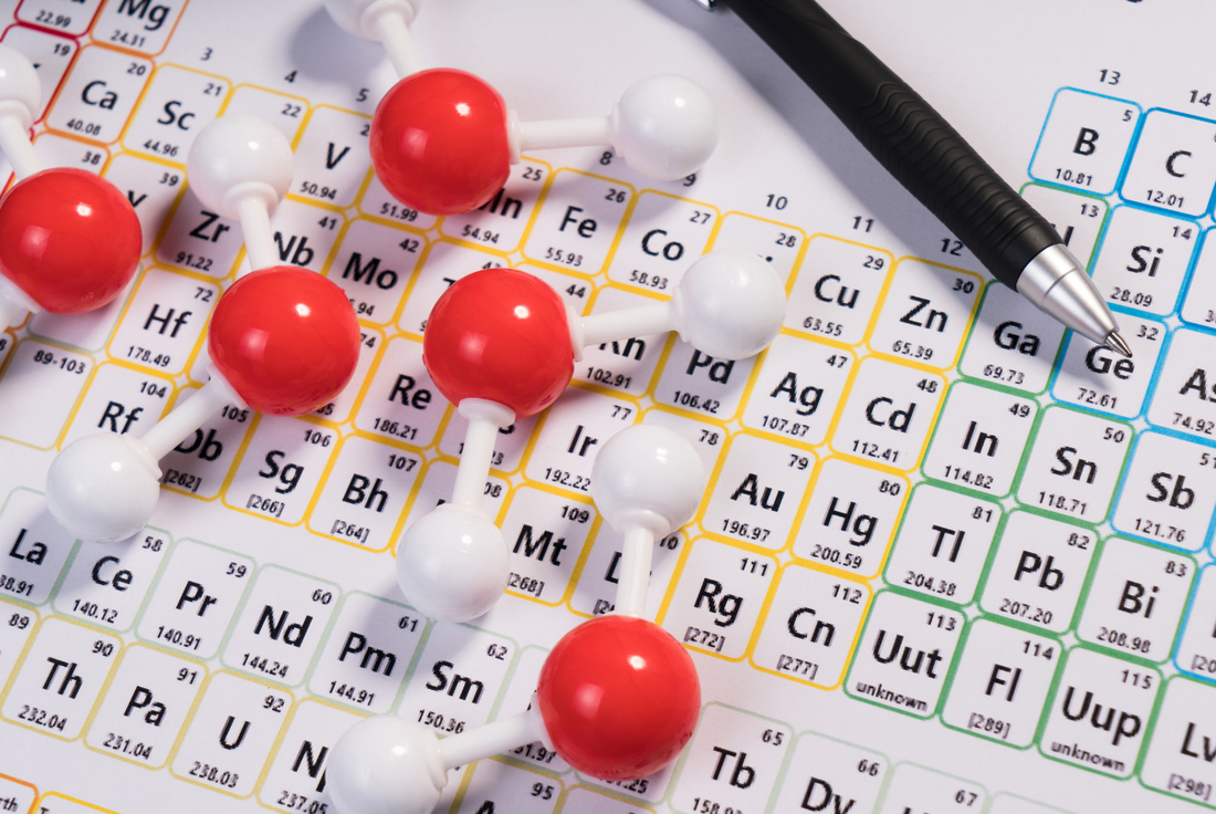 Picture of the periodic table of elements and a molecular model.