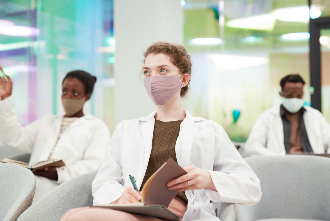 Medical students listening to a lecture and taking notes.