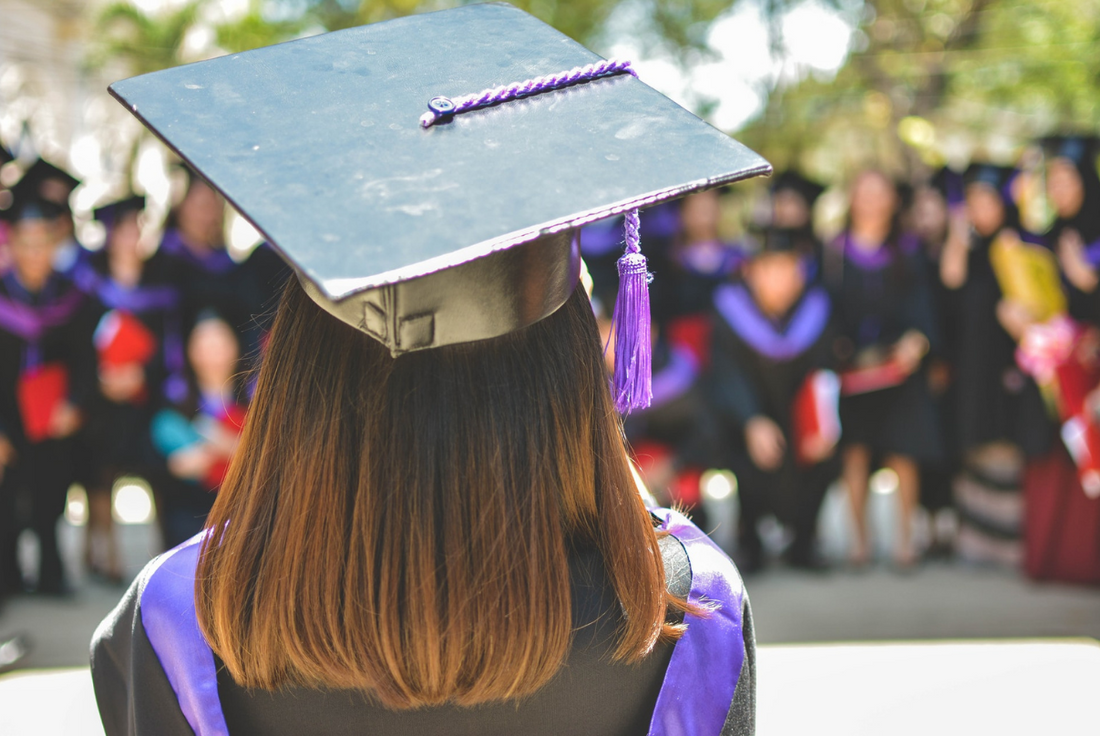 Back view of person wearing a cap and gown.